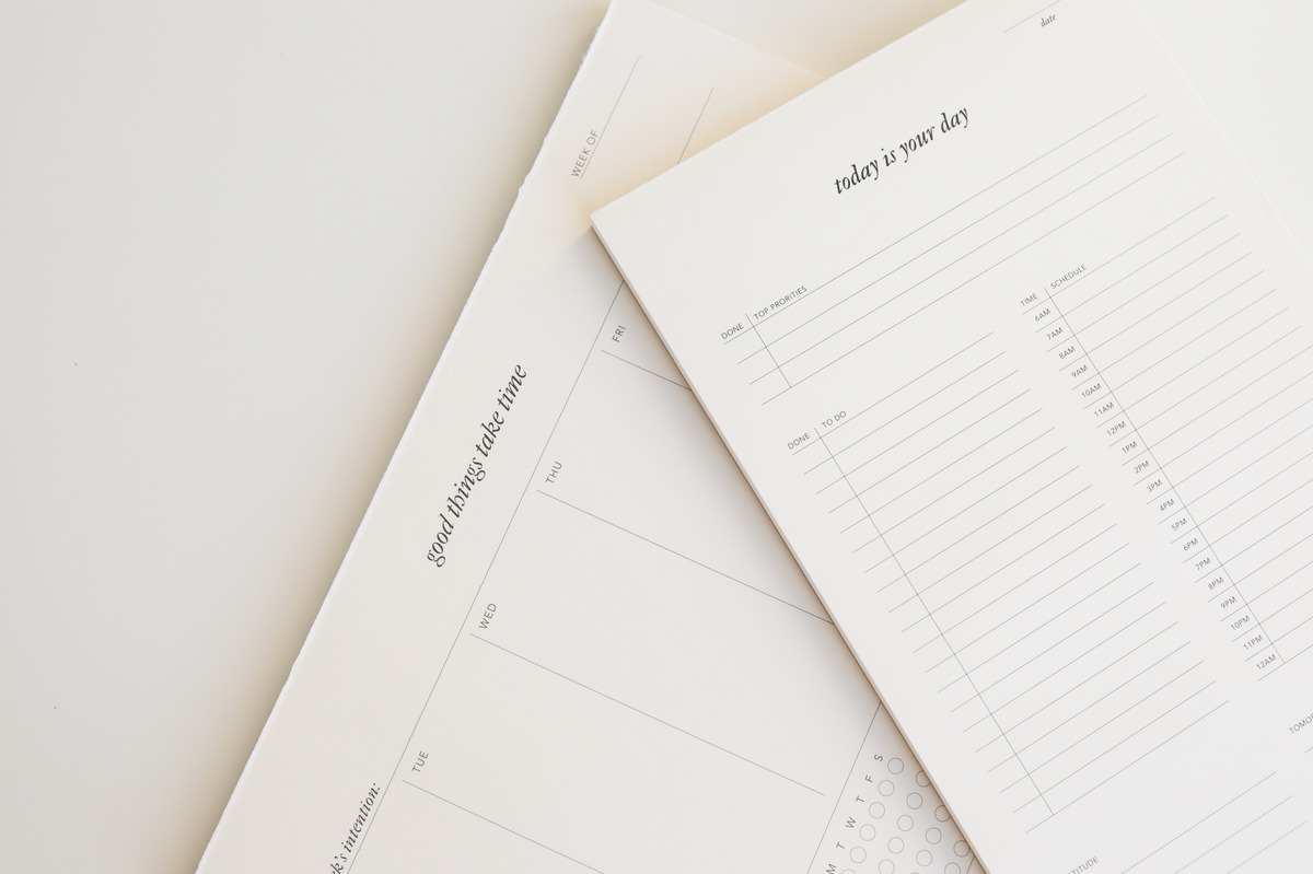 Planning Set showing Good Things Take Time weekly notepad and Today Is Your Day daily notepad overlapping on white surface | Strawberry Goose