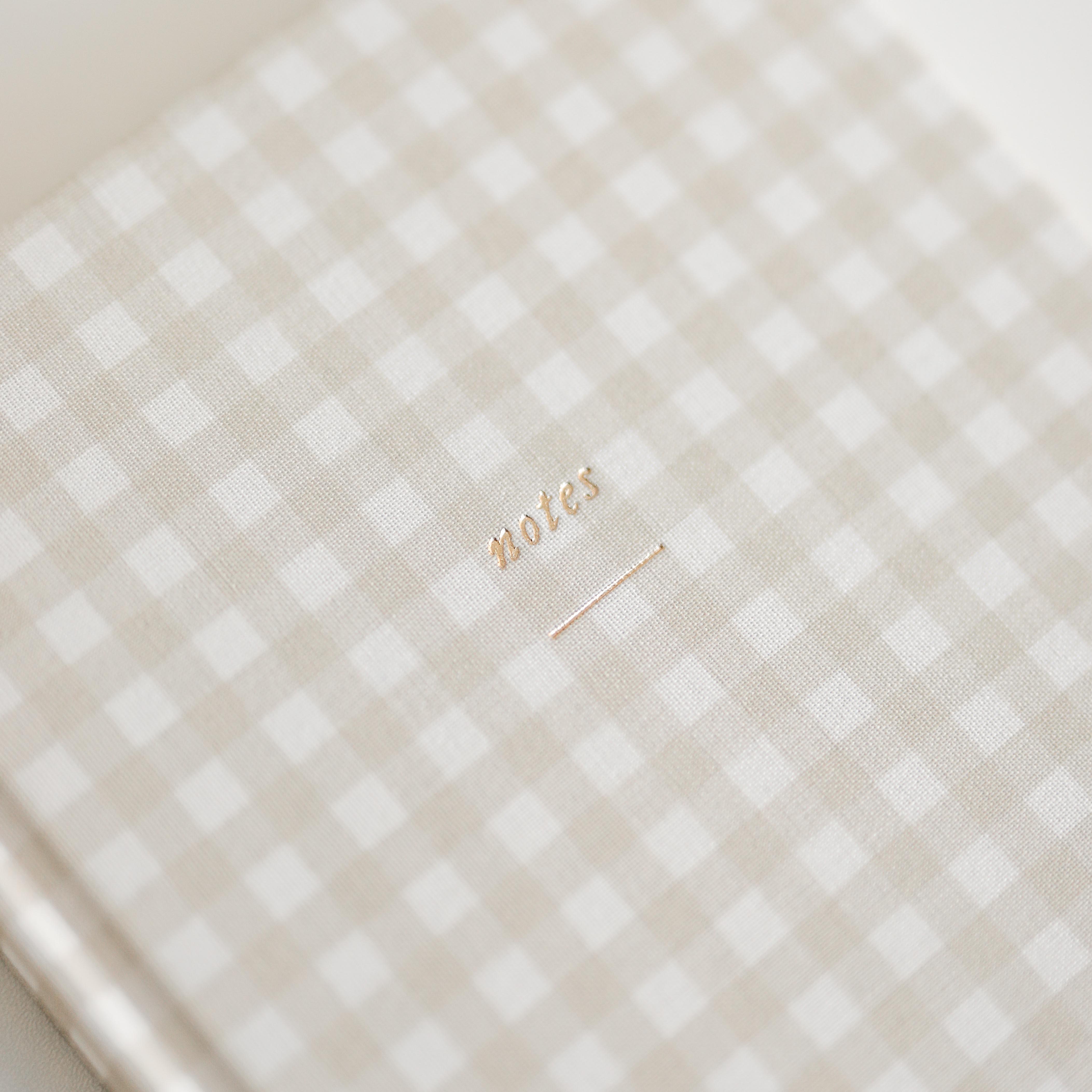 Beige gingham notebook with 'notes' gold-foil lettering