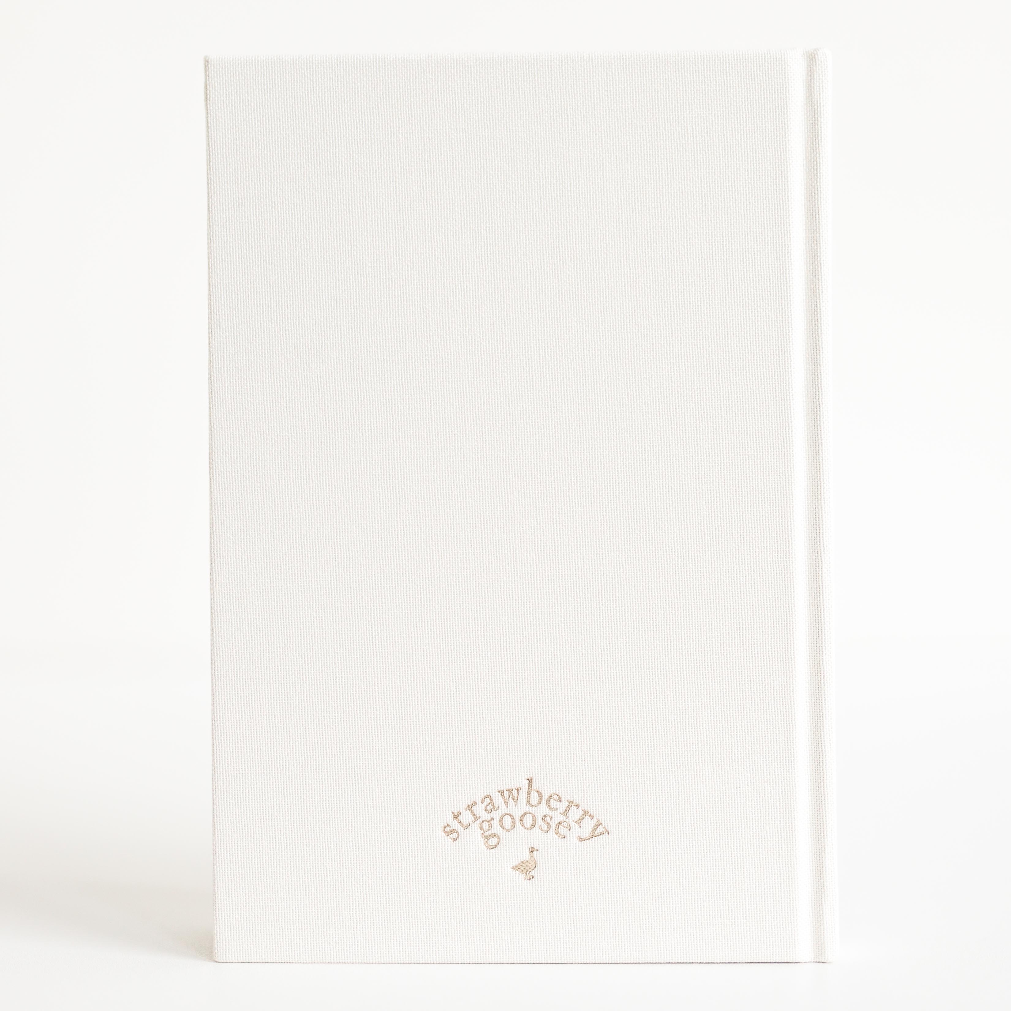 White notebook with 'Strawberry Goose' branding on a white background