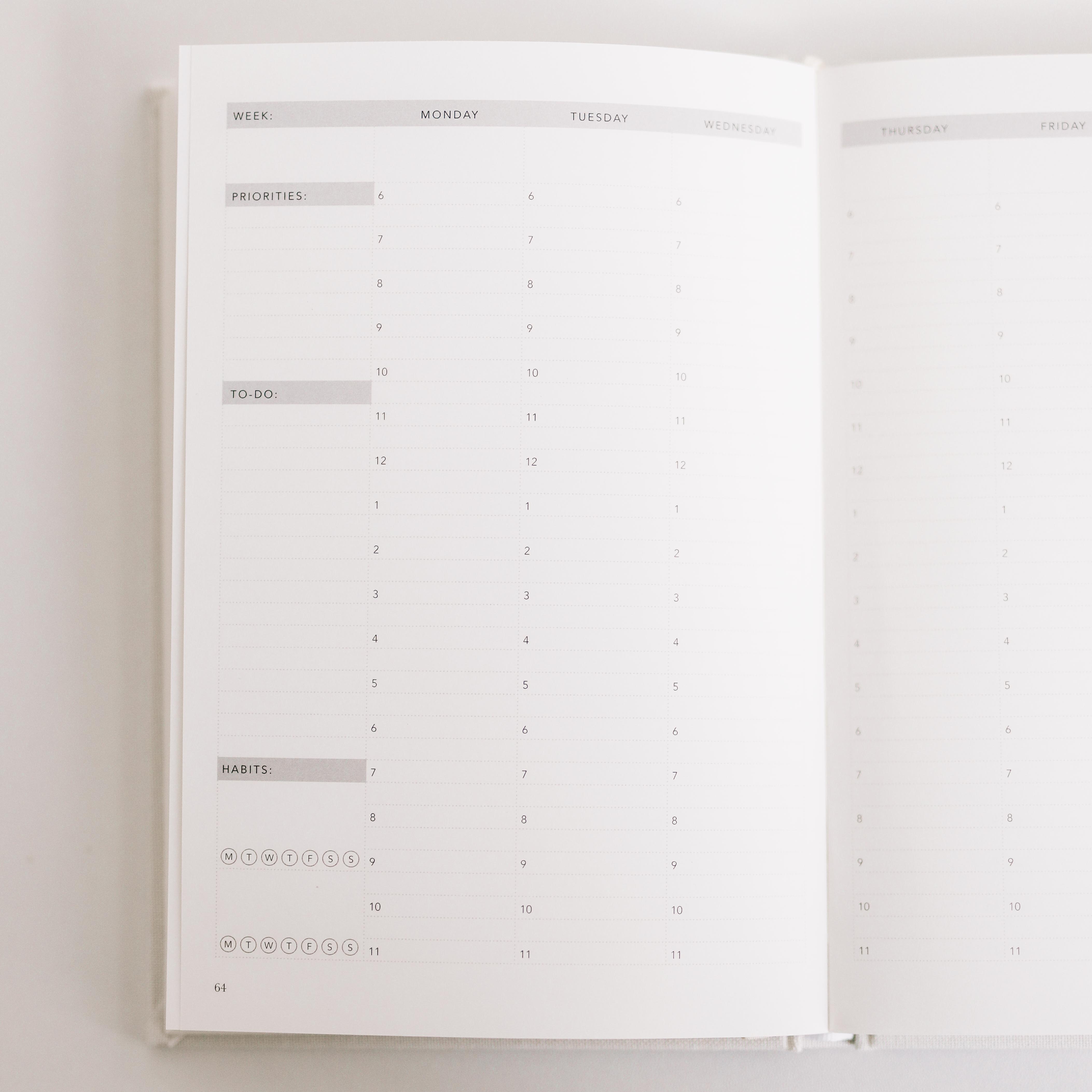 Open planner with a daily schedule layout on a light gray background