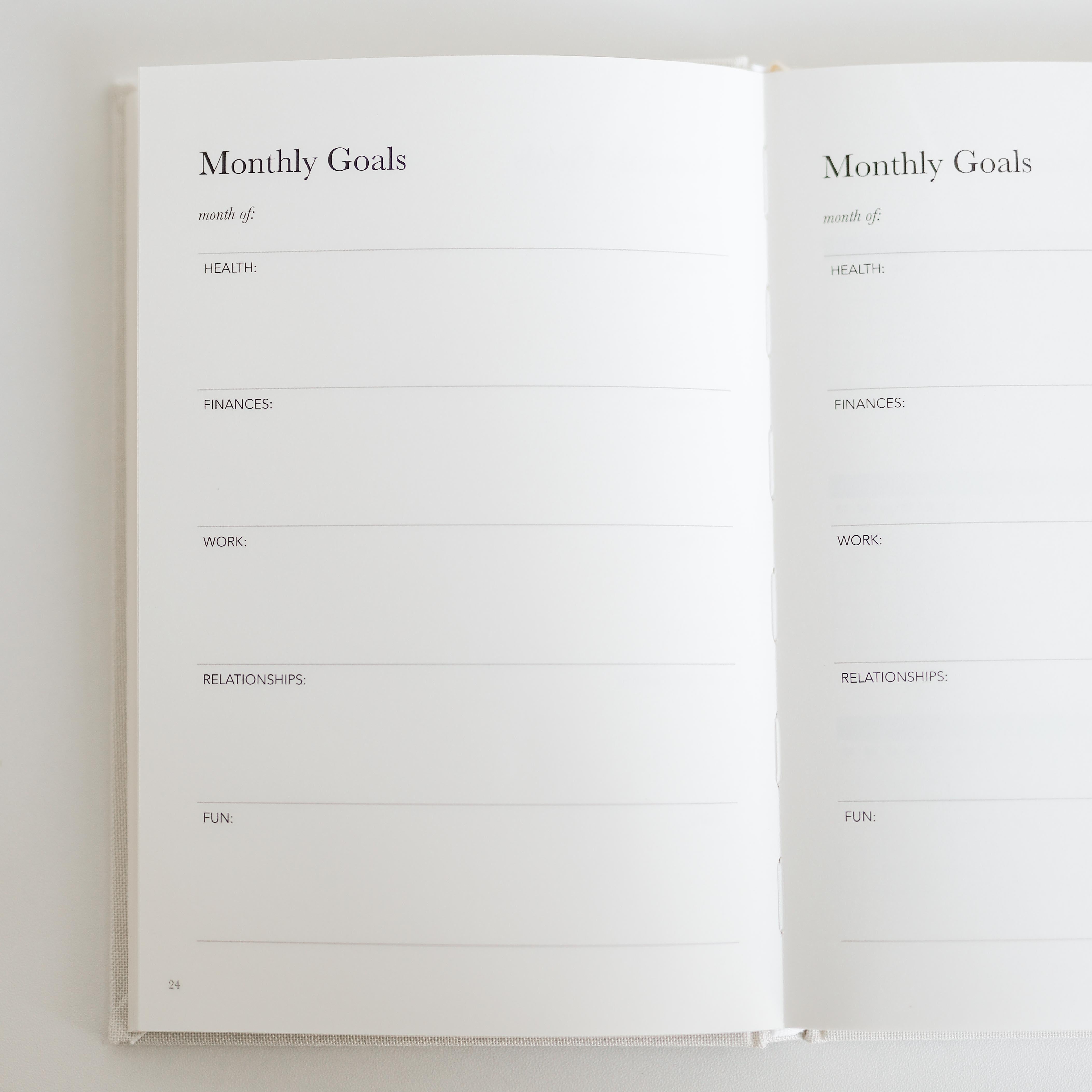 Open notebook with 'Monthly Goals' section on a white background