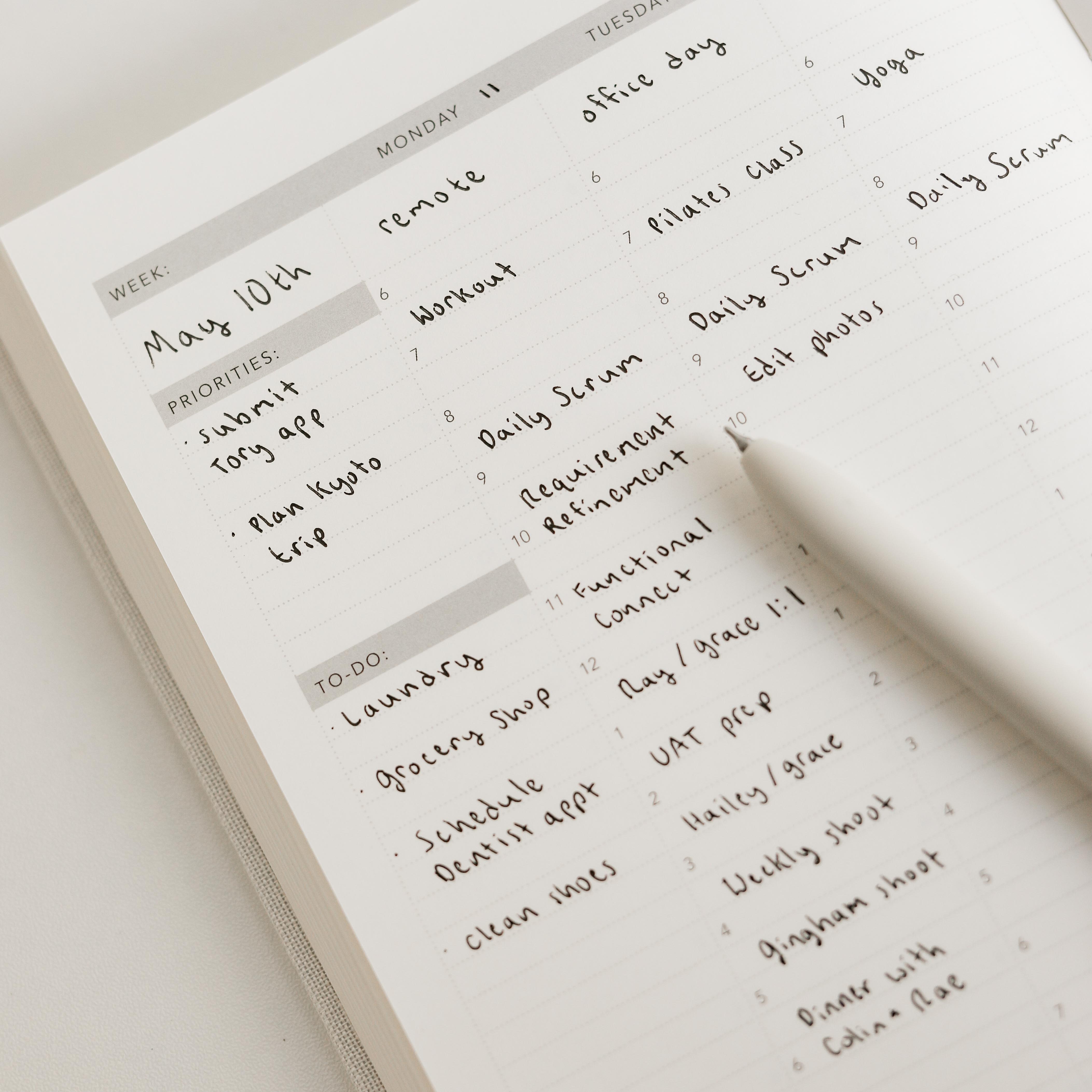 Handwritten planner with tasks and priorities on a light surface
